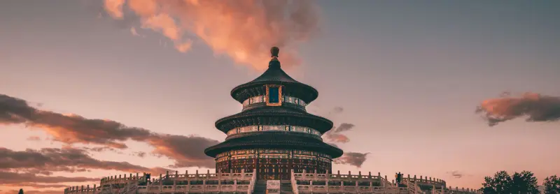Stunning view of the Temple of Heaven in Beijing under a vibrant sunset sky.