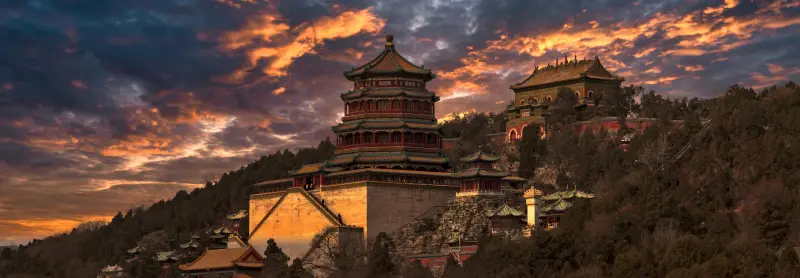 The Summer Palace in Beijing at sunset, showcasing traditional Chinese architecture.